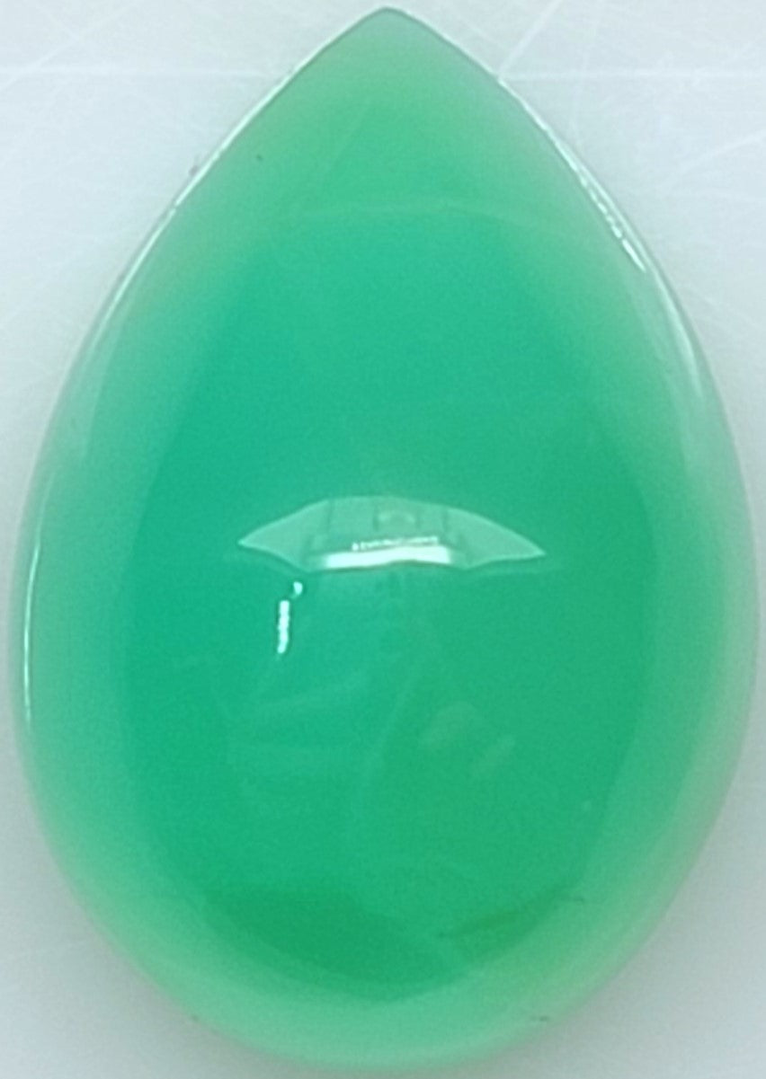 A teardrop-shaped green gemstone cabochon with a smooth, polished surface and a glossy finish, shown against a light gray background.