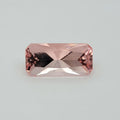 A rectangular pink gemstone with a faceted appearance, centered on a light gray background.