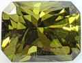 Faceted green gemstone on a white background