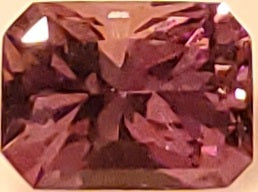 Rectangular purple gemstone on a white background