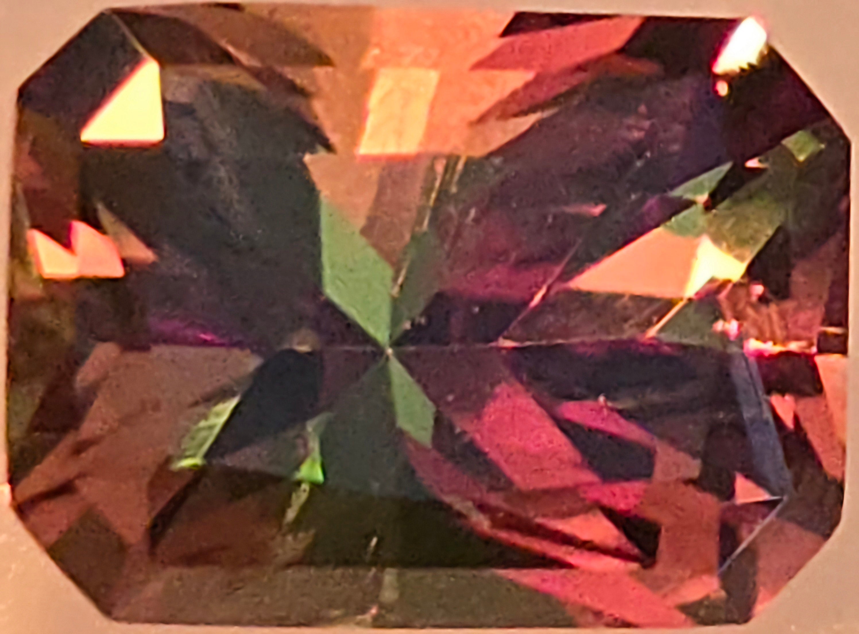 Burgundy gemstone with a faceted surface