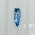 A faceted pear-shaped blue gemstone, centered on a clean white background.