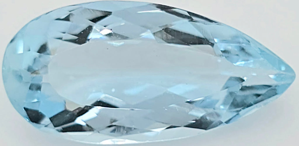 A faceted teardrop-shaped light blue gemstone, shown on a plain light background.