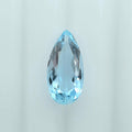 A single faceted teardrop-shaped light blue gemstone, centered on a clean white background.