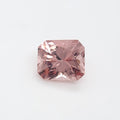 A single rectangular radiant cut pink gemstone with faceted edges, centered on a plain white background.