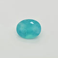A faceted oval greenish blue gemstone with natural inclusions, shown on a plain white background.