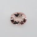 Transparent oval pink gemstone on a white background
