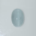 Oval domed light blue gemstone cabochon on a white background