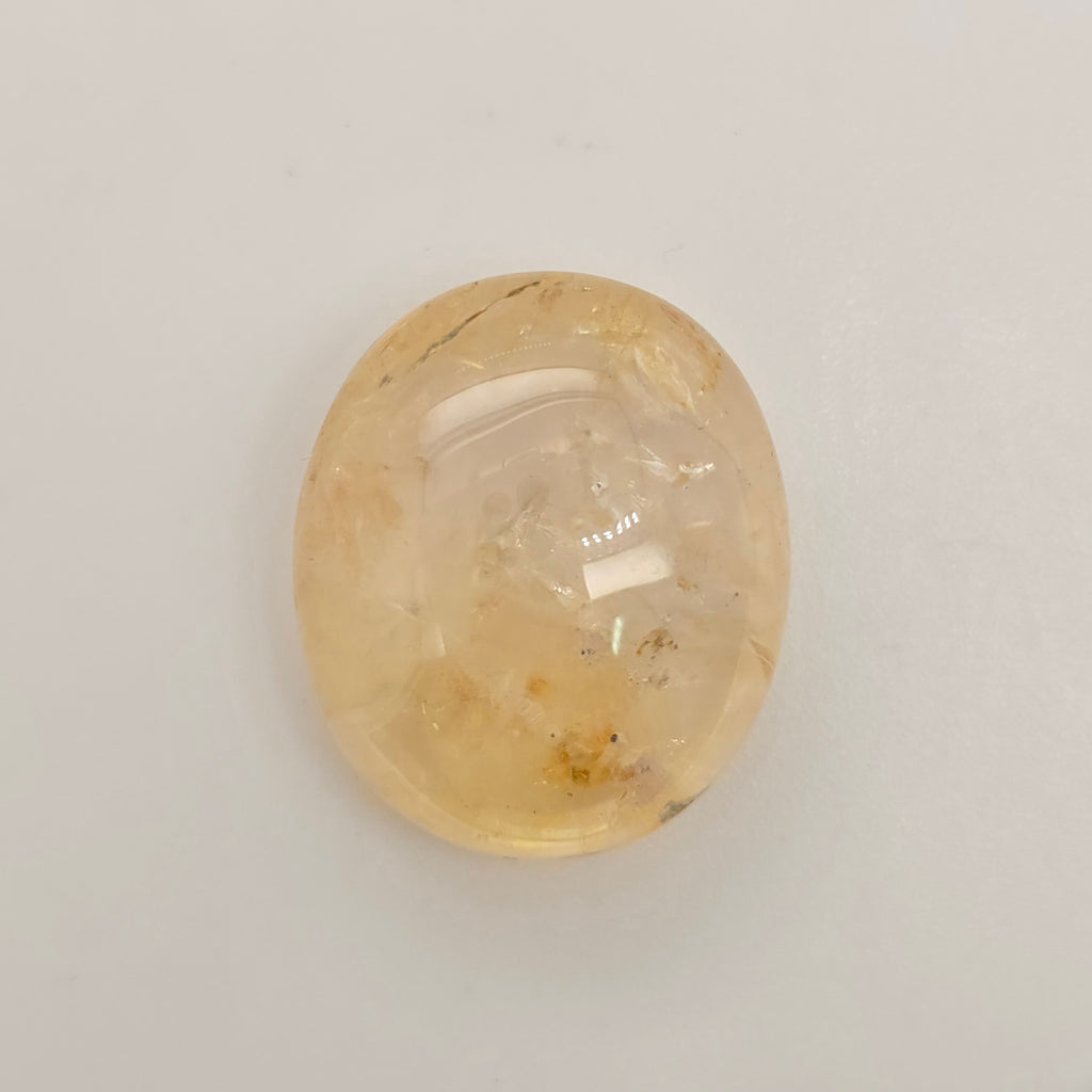 Oval-shaped Sapphire stone on a light gray background