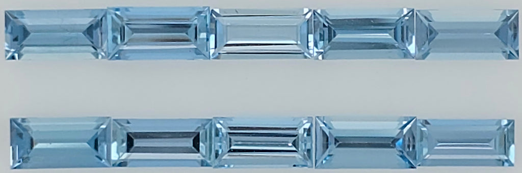 Two horizontal rows of faceted light blue rectangular gemstones shown on a plain light gray background.