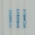 Image of nine rectangular light blue faceted stones arranged into three columns on a plain white background