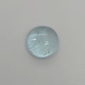 Round light blue domed gemstone against a light background