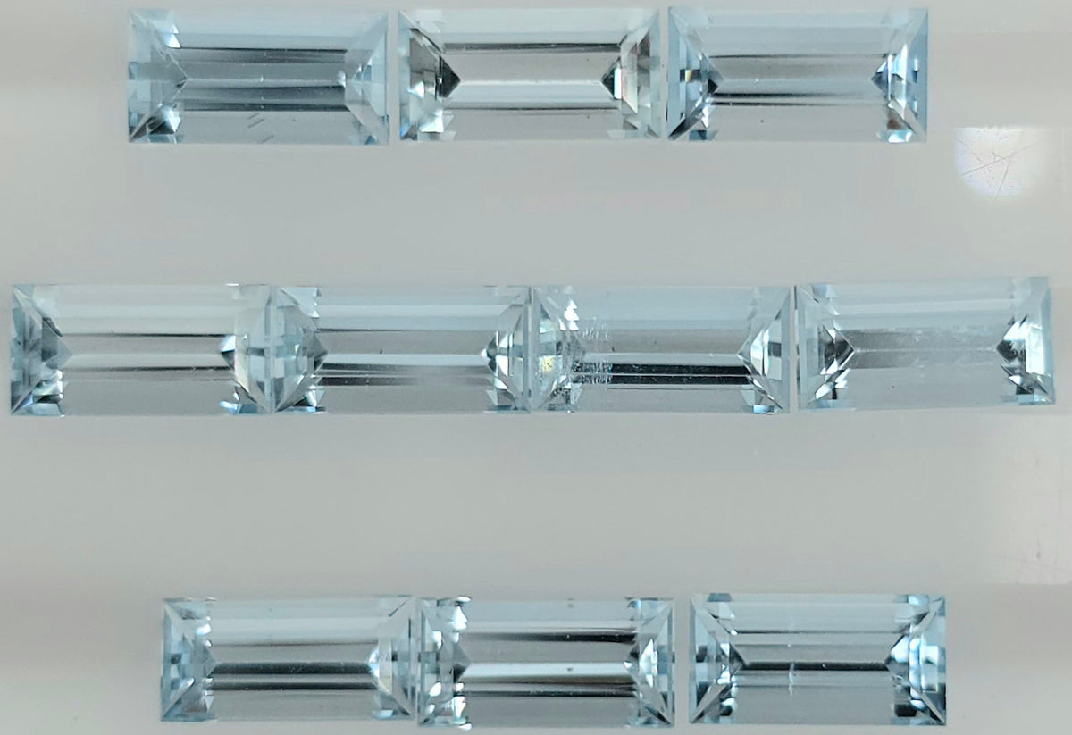 Ten faceted light blue gemstone rectangles arranged into three rows on a plain white background