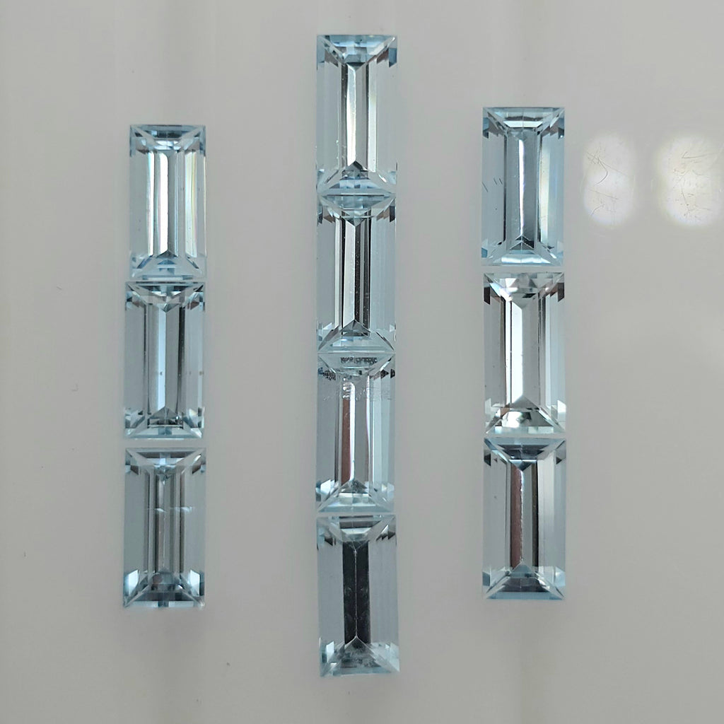 Ten light blue faceted rectangle gemstones arranged into three columns against a white background