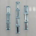 Ten light blue faceted rectangle gemstones arranged into three columns against a white background