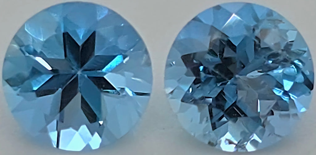 Ac close up of two round blue gemstones shown side by side on a plain light background