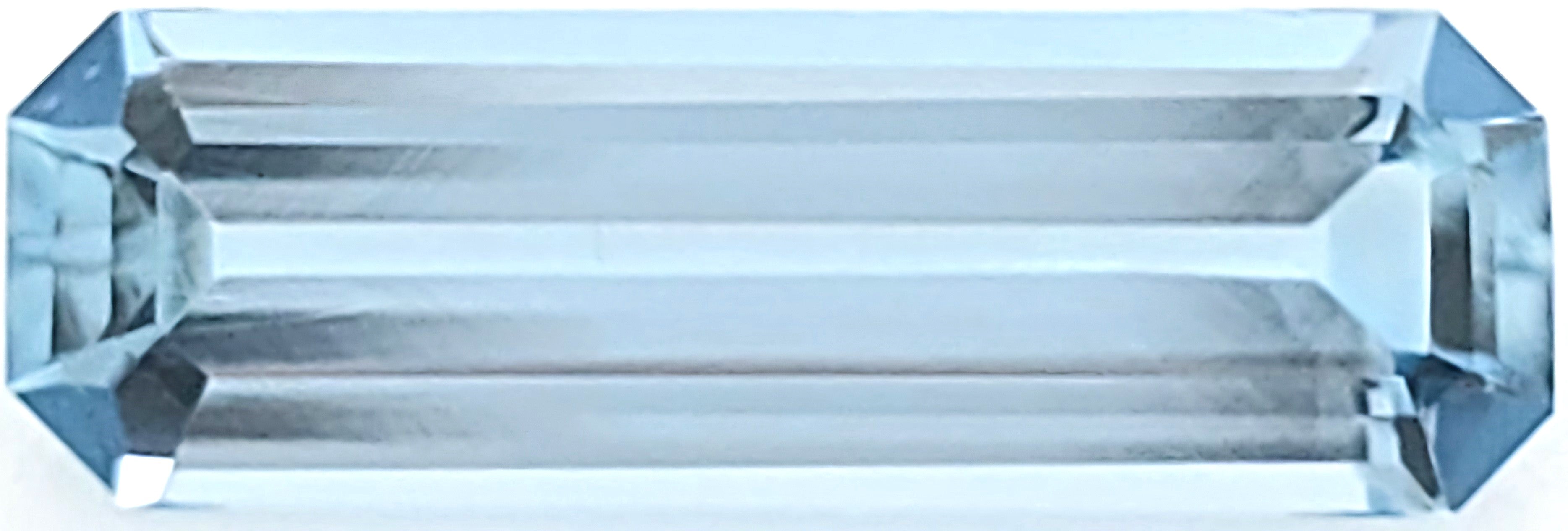 A rectangular, faceted light blue gemstone shown on a plain white background.