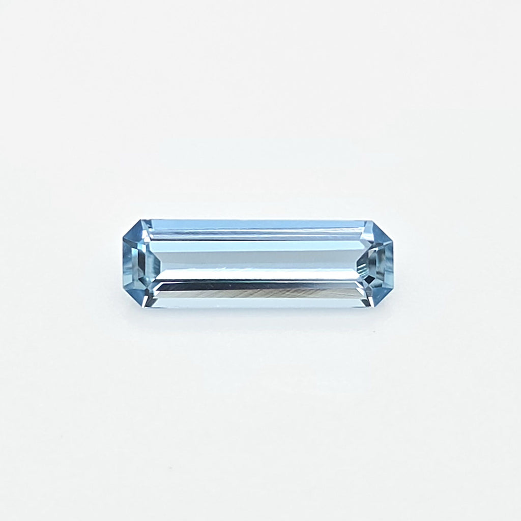 A light blue rectangular emerald-cut gemstone centered on a clean white background.