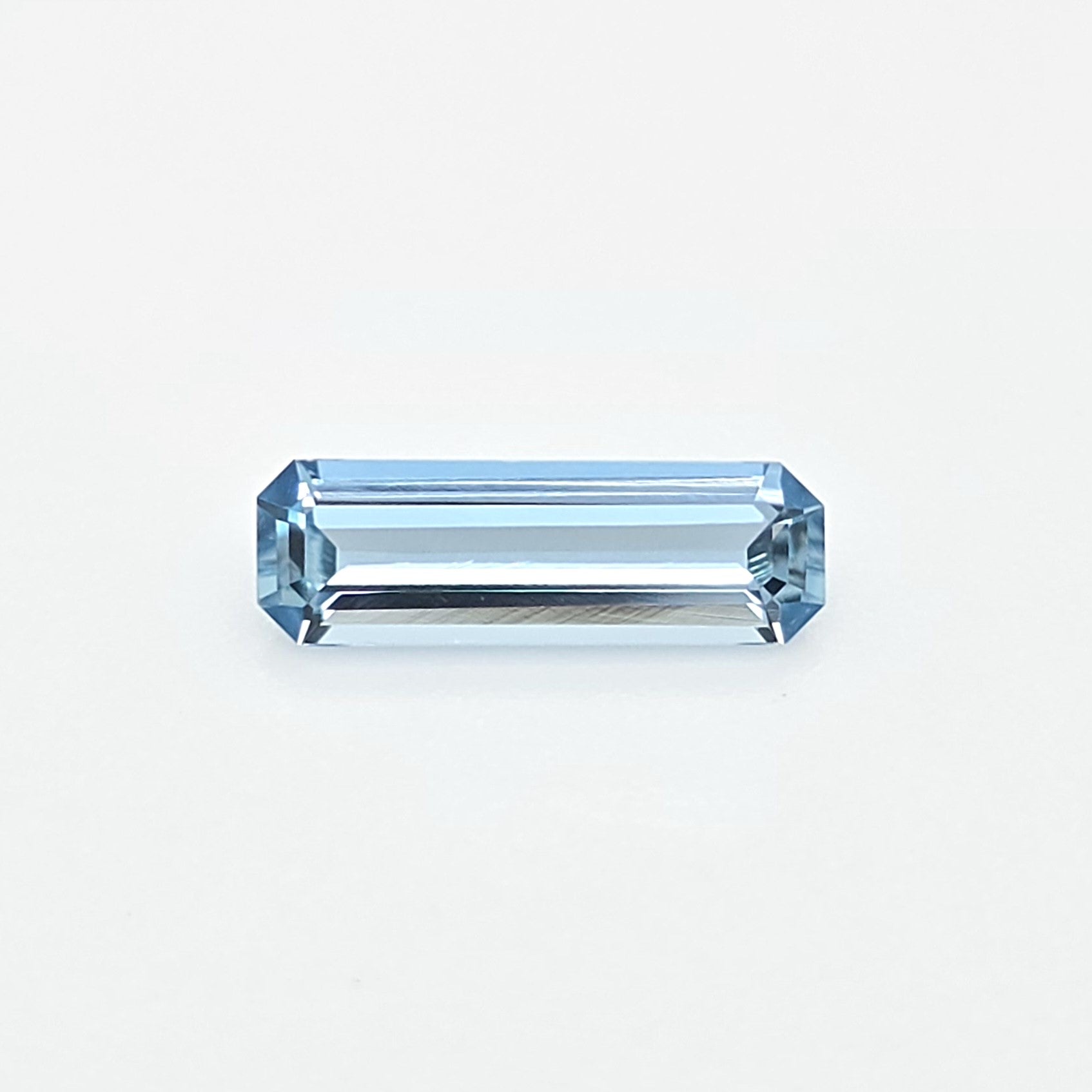A light blue rectangular emerald-cut gemstone centered on a clean white background.