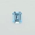 A single light blue emerald-cut faceted gemstone centered on a plain light gray background.