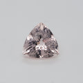 A triangular cut pink gemstone with brilliant faceting, centered on a light gray background.