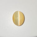 An oval cat's eye gemstone with a pale yellow body and a distinct white split reflection, displayed on a clean white background.