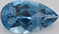 A faceted pear-shaped blue gemstone, shown in close-up on a plain light background.
