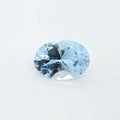 An oval-cut light blue gemstone with a faceted, brilliant cut, displayed on a clean white background.