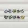Ten faceted round gemstones arranged in two rows on a white background, showing a mix of silver, green, pink, and yellow tones.