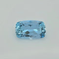 A light blue cushion-cut faceted gemstone centered on a plain light gray background.
