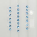 22 light blue round faceted blue gemstones arranged in three vertical columns on a plain white background.