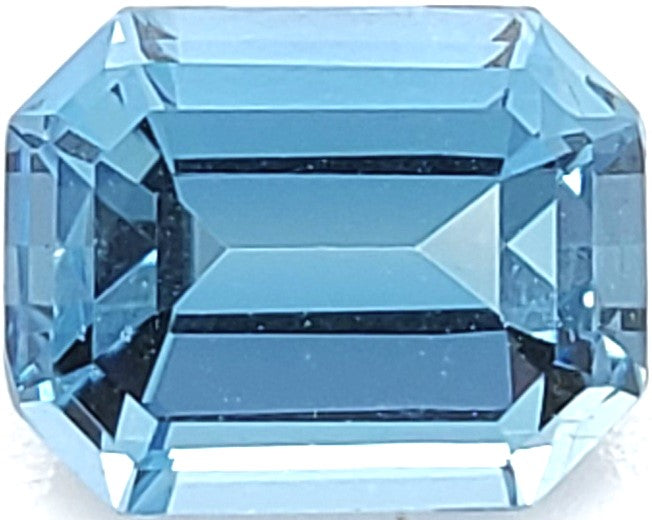 A light blue emerald-cut faceted gemstone shown on a plain white background.