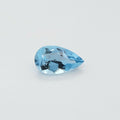 A single faceted pear-cut light blue gemstone, displayed on a clean, light gray-white background.