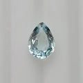 A single faceted pear-shaped light blue gemstone centered on a plain light gray background.