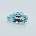 A single pear-shaped light blue gemstone with a faceted cut, displayed on a clean, light gray background.